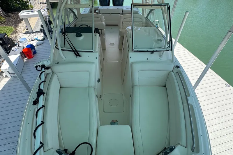 Slide: The Image of 2022 Grady-White Freedom 285 boat on clear blue water, featuring dual engines. - 22