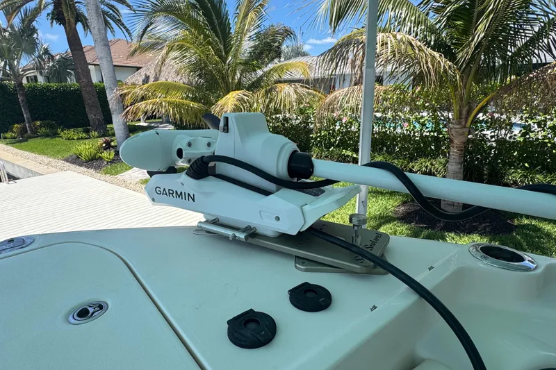 Slide: The Image of 2022 Grady-White Freedom 285 boat cruising on blue waters near coastal buildings. - 24