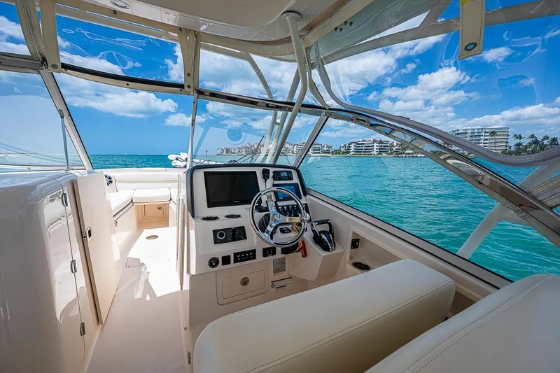 Slide: The Image of 2022 Grady-White Freedom 285 boat interior with ocean view and modern dashboard. - 35