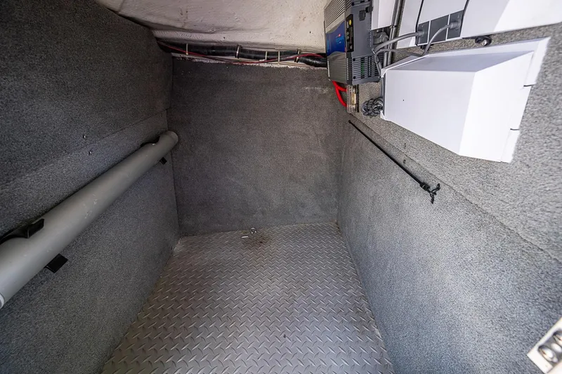 Slide: The Image of Interior storage compartment of 2022 Grady-White Freedom 285 boat, featuring carpeted walls and equipment. - 39