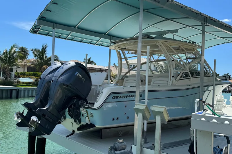 Slide: The Image of 2022 Grady-White Freedom 285 boat cruising on clear blue water under a partly cloudy sky. - 4