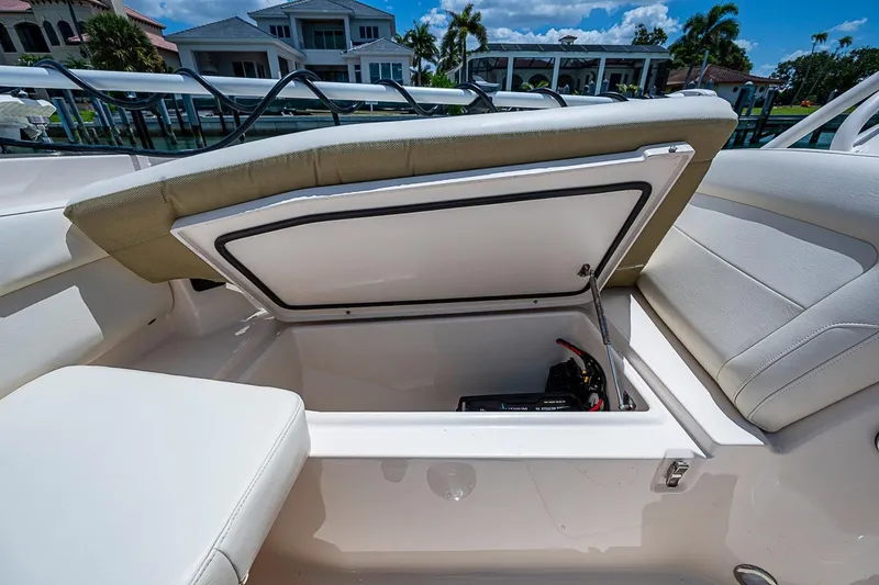 Slide: The Image of 2022 Grady-White Freedom 285 boat storage compartment with open lid, showcasing interior details. - 43