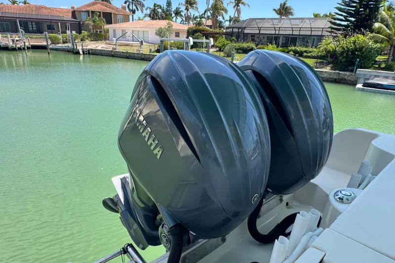 Slide: The Image of 2022 Grady-White Freedom 285 boat cruising on clear blue water under a cloudy sky. - 5
