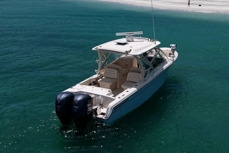 Slide: The Image of 2022 Grady-White Freedom 285 boat on clear turquoise water near sandy beach. - 51