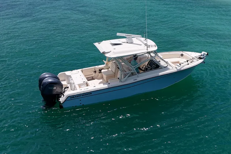 Slide: The Image of 2022 Grady-White Freedom 285 boat cruising on clear turquoise water. - 52