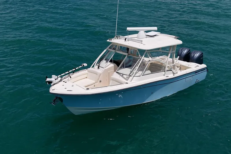 Slide: The Image of 2022 Grady-White Freedom 285 boat on clear blue water. - 53