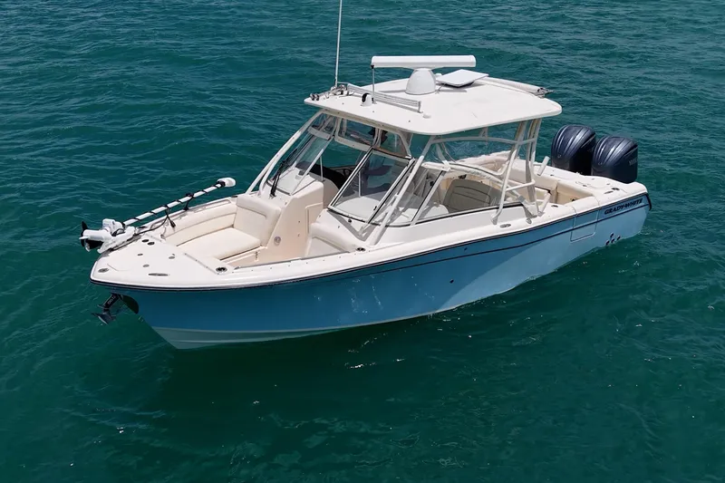 Slide: The Image of 2022 Grady-White Freedom 285 boat on clear blue water. - 54