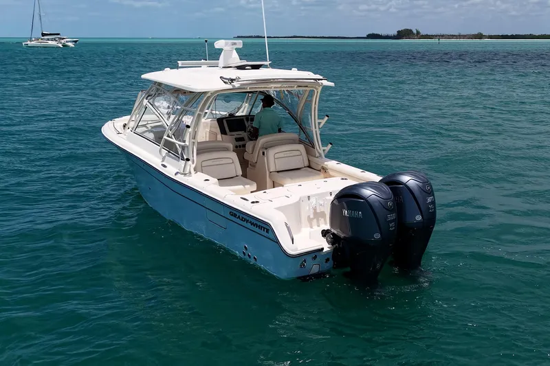 Slide: The Image of 2022 Grady-White Freedom 285 boat with dual Yamaha engines on clear blue water. - 57