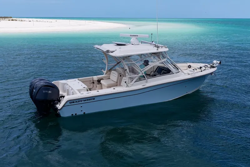 Slide: The Image of 2022 Grady-White Freedom 285 boat on clear turquoise water near a sandy beach. - 58