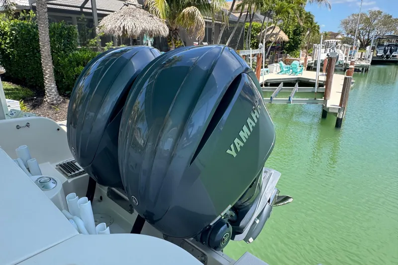 Slide: The Image of 2022 Grady-White Freedom 285 boat cruising on clear blue water. - 6