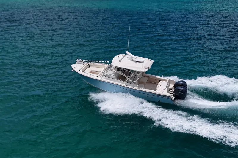 Slide: The Image of 2022 Grady-White Freedom 285 cruising on clear blue ocean waters. - 61