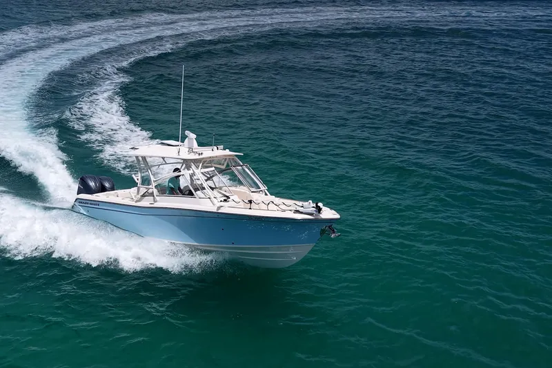 Slide: The Image of 2022 Grady-White Freedom 285 boat cruising on clear blue ocean waters. - 63