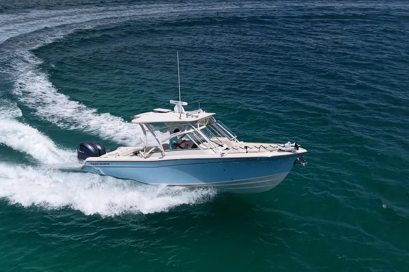 Slide: The Image of 2022 Grady-White Freedom 285 boat cruising on open blue water. - 64