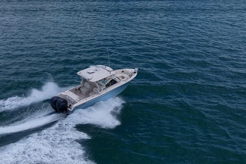 Slide: The Image of 2022 Grady-White Freedom 285 boat cruising on open water. - 66
