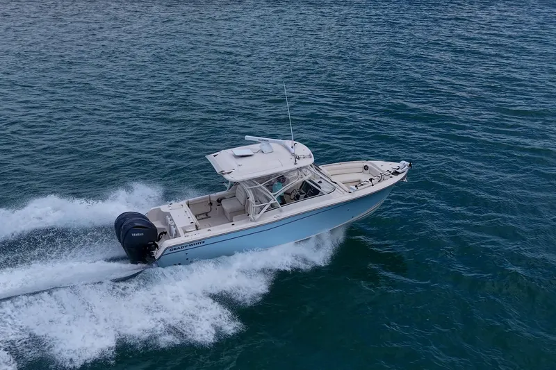 Slide: The Image of 2022 Grady-White Freedom 285 boat cruising on open water. - 68