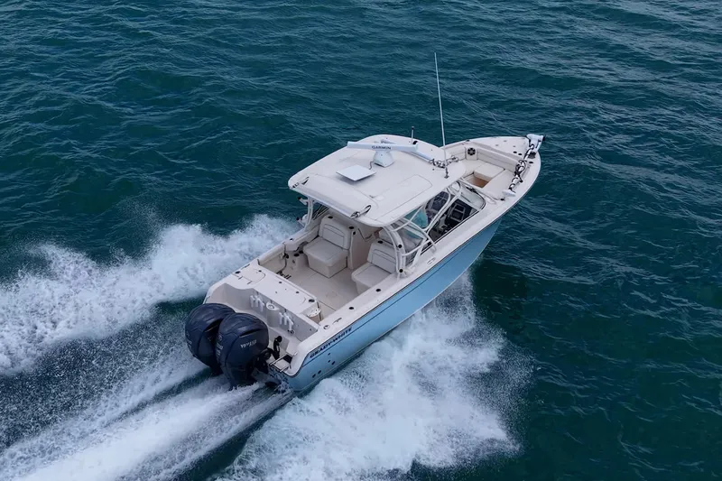 Slide: The Image of 2022 Grady-White Freedom 285 boat cruising on open water, showcasing dual engines. - 72