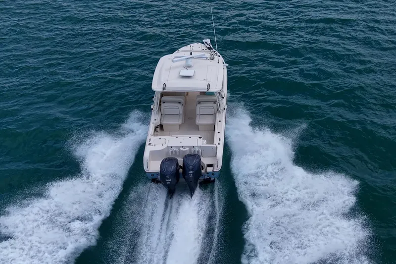 Slide: The Image of 2022 Grady-White Freedom 285 boat cruising on open water. - 74