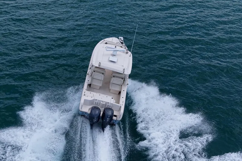 Slide: The Image of 2022 Grady-White Freedom 285 boat cruising on open water, aerial view. - 76