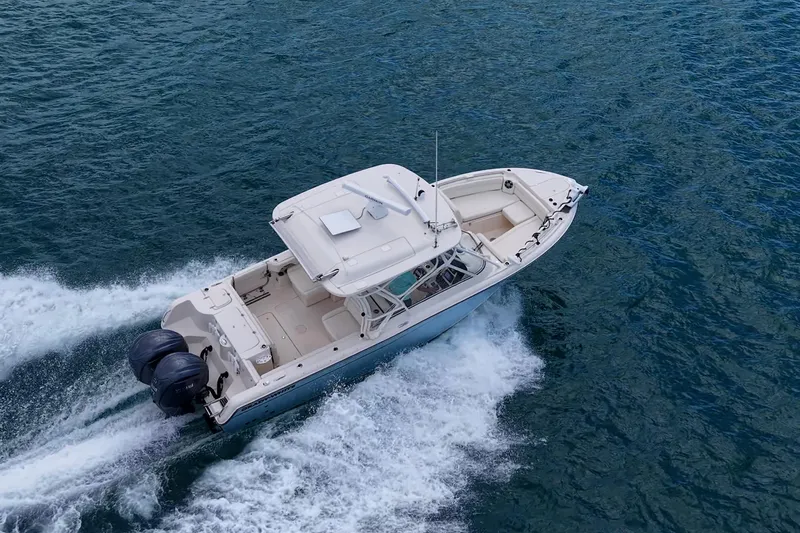 Slide: The Image of 2022 Grady-White Freedom 285 boat cruising on open water, aerial view. - 77