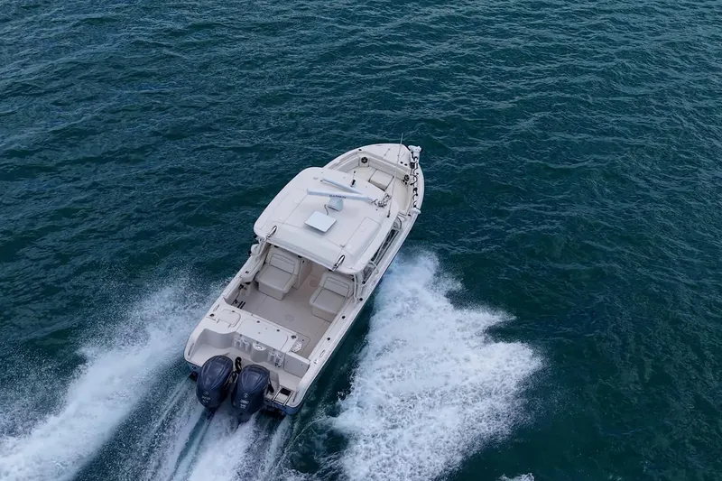 Slide: The Image of 2022 Grady-White Freedom 285 boat cruising on open water. - 78