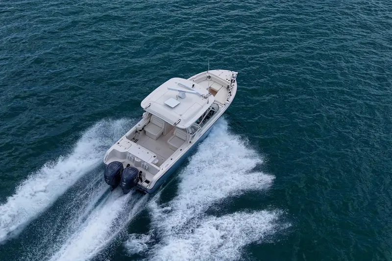 Slide: The Image of 2022 Grady-White Freedom 285 boat cruising on open water. - 79