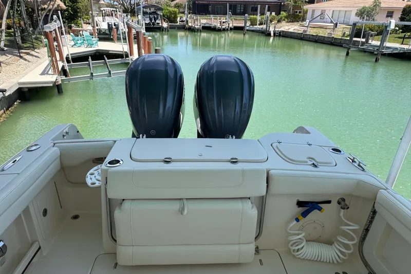 Slide: The Image of 2022 Grady-White Freedom 285 boat cruising on clear blue water. - 8