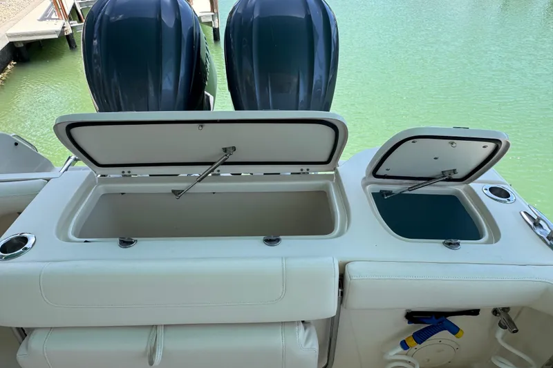 Slide: The Image of 2022 Grady-White Freedom 285 boat cruising on clear turquoise waters. - 9