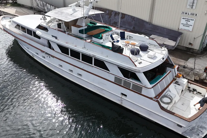 Slide: The Image of Aerial view of a 1990 Denison 109 yacht docked by a waterfront. - 18