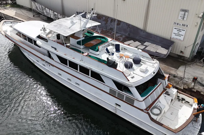 Slide: The Image of Aerial view of a 1990 Denison 109 yacht docked at a marina. - 19