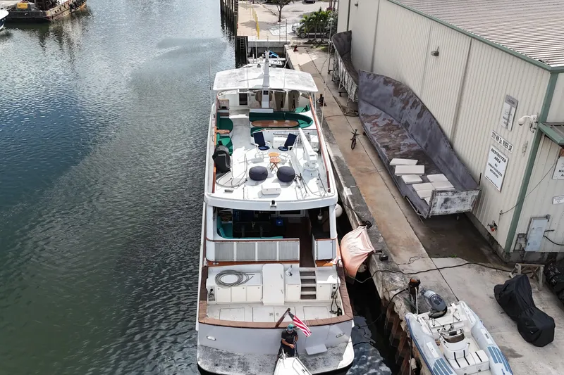 Slide: The Image of Aerial view of a 1990 Denison 109 yacht docked beside a warehouse. - 20