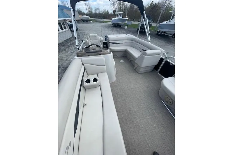 Slide: The Image of 2015 Bennington S20 pontoon boat interior with beige seating and cup holders. - 4