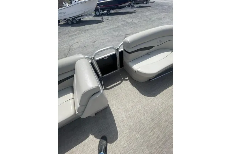 Slide: The Image of 2015 Bennington S20 pontoon boat interior with beige seating and open gate. - 6