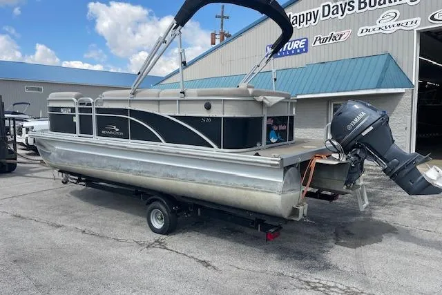 Slide: The Image of 2015 Bennington S20 pontoon boat on trailer, parked outside a boat dealership. - 8