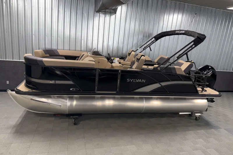 The Image of 2026 Sylvan L1 LZ pontoon boat in showroom, featuring sleek black design and comfortable seating. - 1