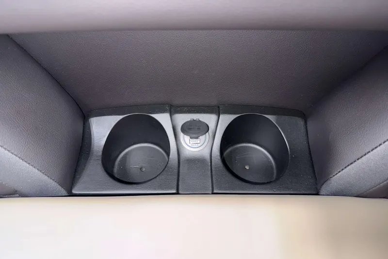 Slide: The Image of 2026 Sylvan L1 LZ cup holders and power outlet in vehicle interior. - 21