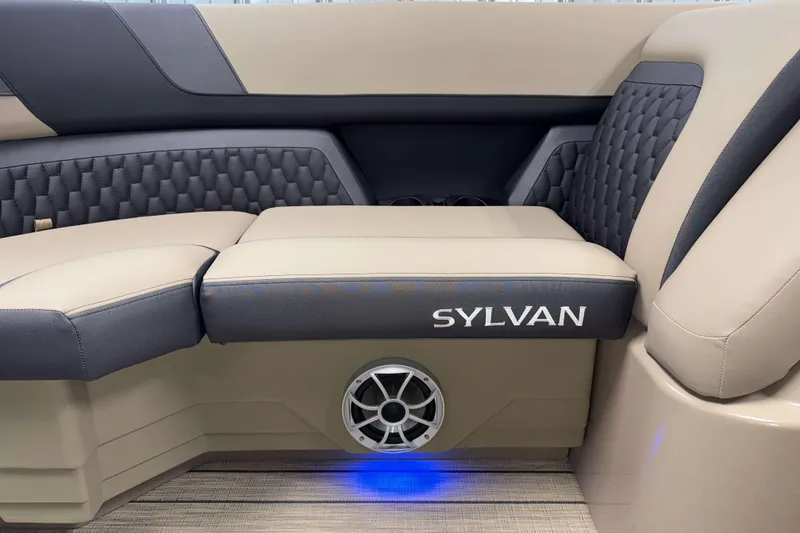 Slide: The Image of 2026 Sylvan L1 LZ boat interior with beige and gray seating, speaker, and ambient lighting. - 22