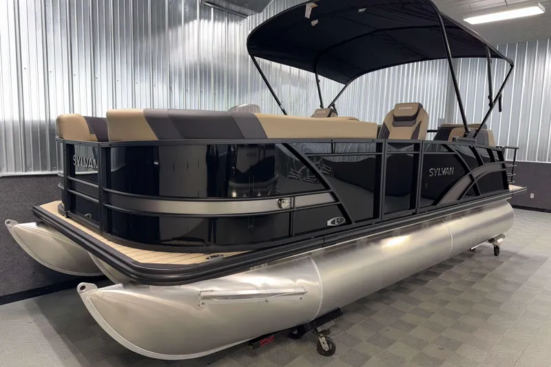 Slide: The Image of 2026 Sylvan L1 LZ pontoon boat with sleek black design and spacious seating. - 23