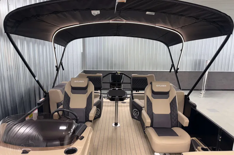Slide: The Image of 2026 Sylvan L1 LZ pontoon boat interior with canopy and luxurious seating. - 31