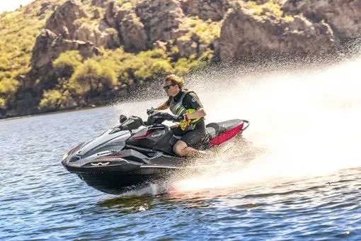 Slide: The Image of 2026 Kawasaki ULTRA 160 LX-S jet ski speeding on a scenic lake. - 3