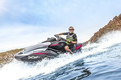 Slide: The Image of Man riding 2026 Kawasaki ULTRA 160 LX-S jet ski on water. - 5