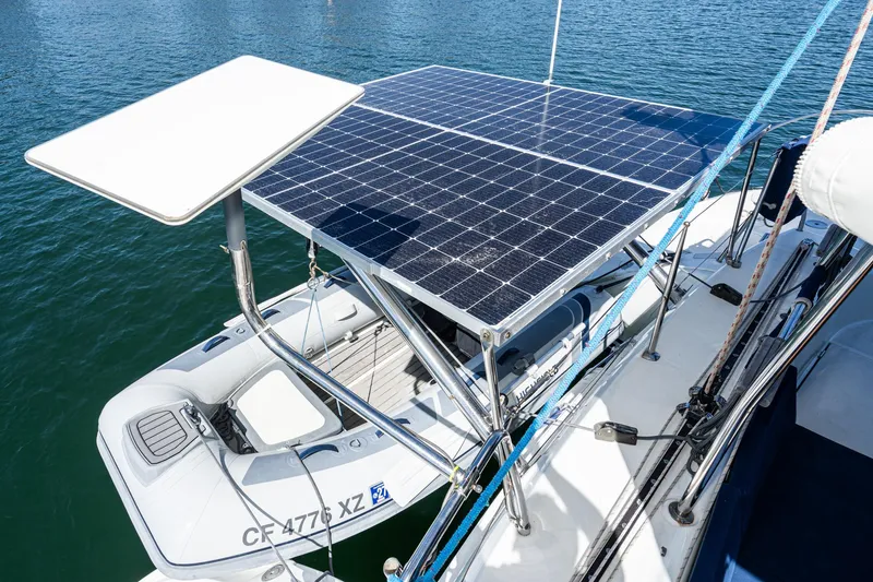 Slide: The Image of Lagoon 380 catamaran with solar panels and dinghy, 2004 model, on water. - 17