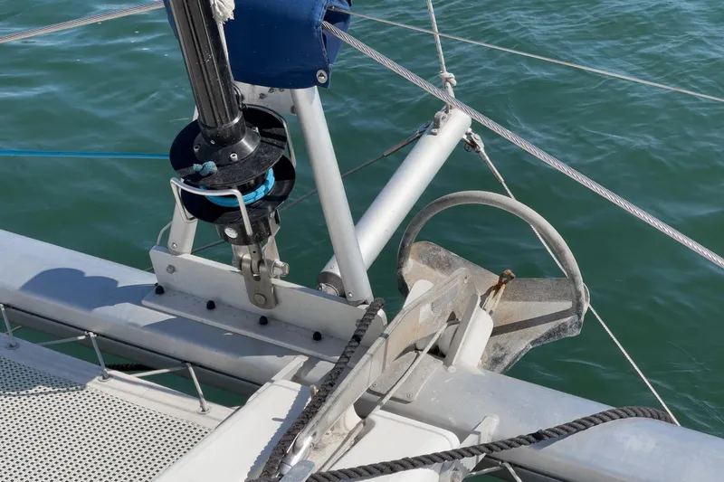 Slide: The Image of Close-up of a 2004 Lagoon 380 sailboat's anchor and rigging system on calm water. - 24