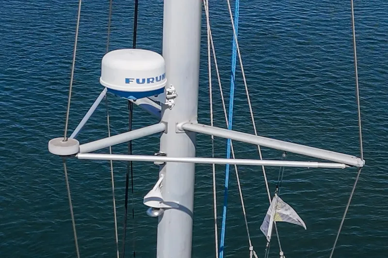 Slide: The Image of Radar equipment on a 2004 Lagoon 380 sailboat mast over water. - 26
