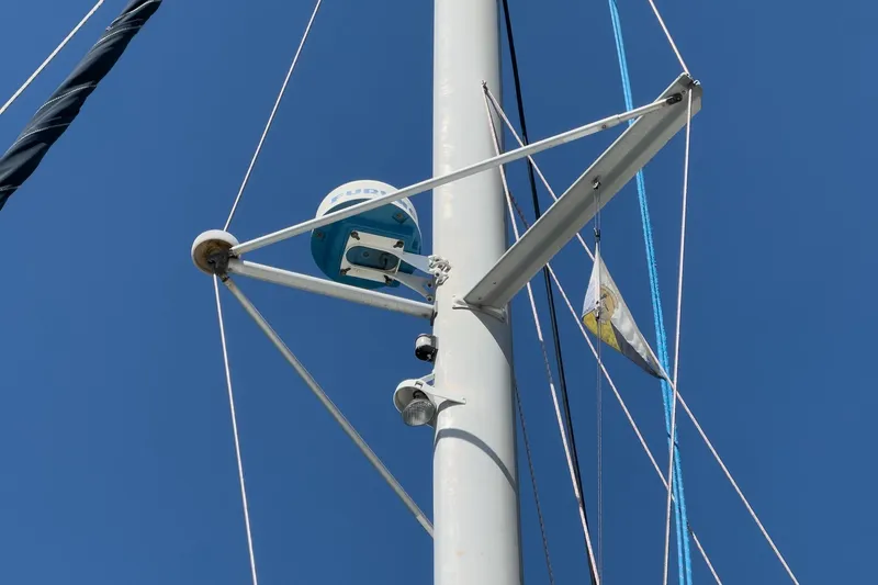 Slide: The Image of Mast of 2004 Lagoon 380 sailboat with radar and rigging against blue sky. - 27