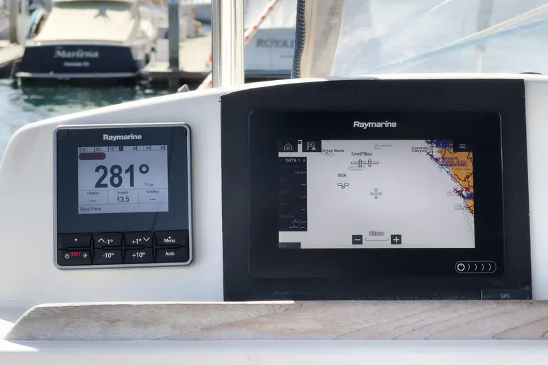 Slide: The Image of Raymarine navigation displays on a 2004 Lagoon 380 catamaran, showing course and map details. - 38