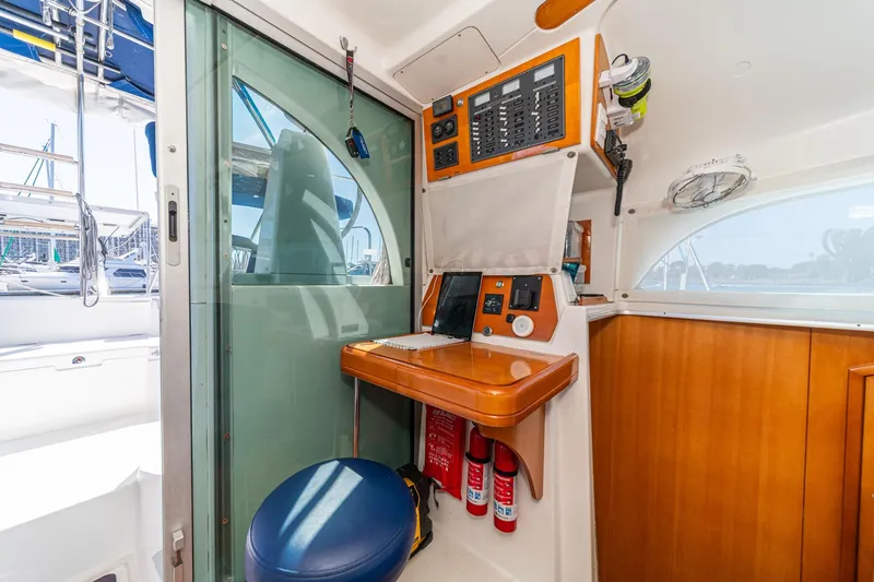 Slide: The Image of Interior of 2004 Lagoon 380 yacht with navigation station and control panel. - 52
