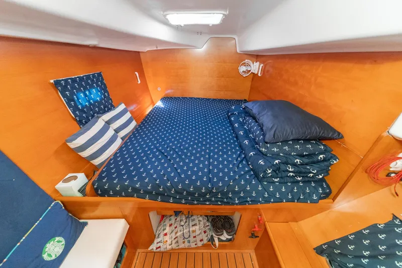 Slide: The Image of Cozy cabin interior of 2004 Lagoon 380 catamaran with nautical-themed bedding. - 57