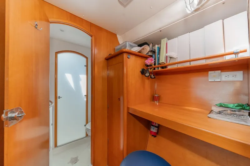 Slide: The Image of Interior of 2004 Lagoon 380 yacht with wooden cabinetry and desk area. - 59