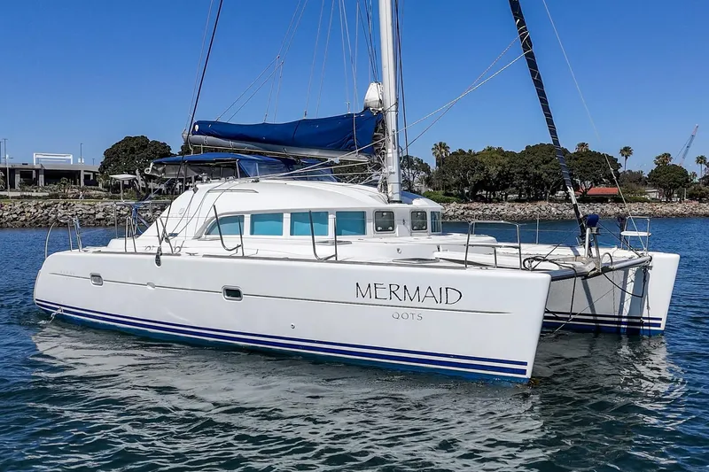 Slide: The Image of 2004 Lagoon 380 catamaran "Mermaid" sailing in calm waters under clear blue skies. - 6
