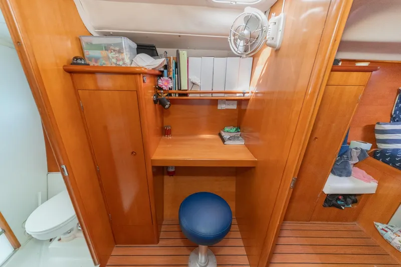 Slide: The Image of Interior of 2004 Lagoon 380 yacht with wooden cabinetry and compact workspace. - 60